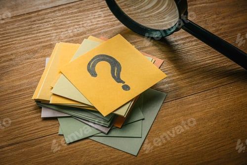 Preview: Questions and answers concept. A stack of paper with a paper on top written with question symbol tog