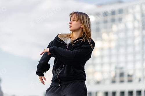 Preview: Young Dancer Performing Urban Dance Routine in City Plaza During Late Afternoon