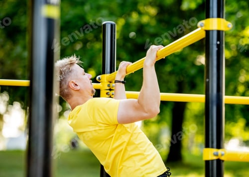Preview: Man excersing with horizontal bar outdoors