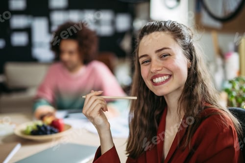 Preview: Young smiling woman with her colleague in work.