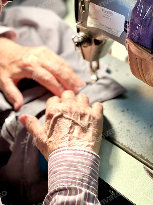Preview: Tailor using his sewing machine.