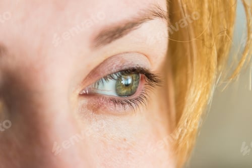 Preview: Closeup shot of a blonde female with beautiful green eyes