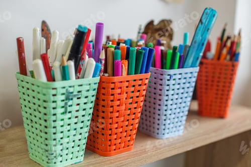 Preview: Colorful Baskets of Markers and Pens in Classroom