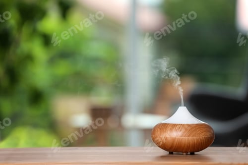Preview: Aroma oil diffuser lamp on table against blurred background