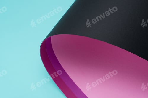 Preview: roll of black and pink paper isolated on turquoise