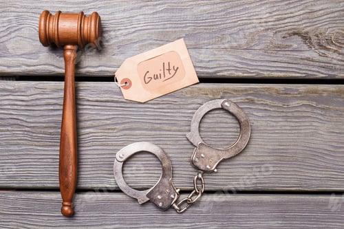 Preview: Gavel and handcuffs on wooden background.