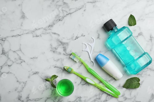 Preview: Flat lay composition with oral care products and space for text on marble background. Teeth hygiene