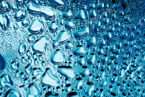 Preview: Water droplets on blue glass macro background