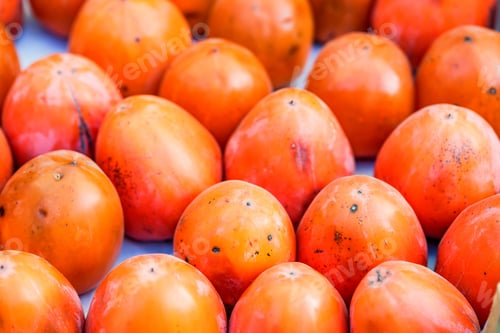 Preview: Persimmon fruits for sale in market close