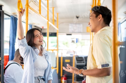 Preview: Asian tourist couple go on trip man and woman holding handrail talking while standing in shuttle bus