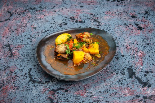 Preview: Top view of delicious dinner with meat potatoes served with green in plate on mix colors background