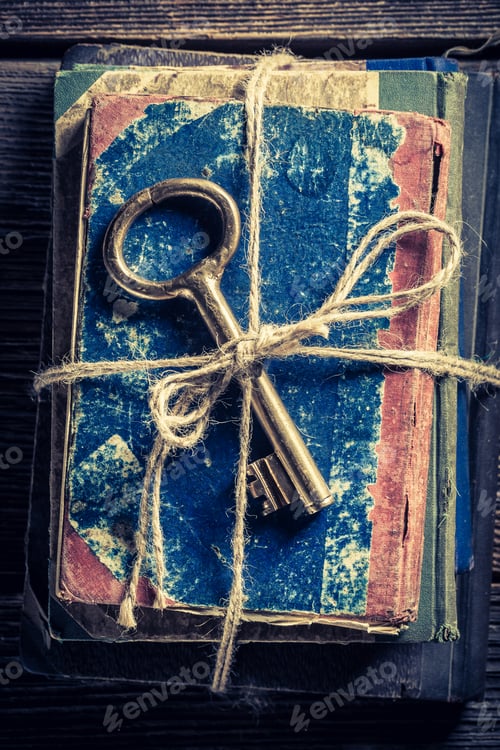 Preview: Vintage books and keys on old wooden table