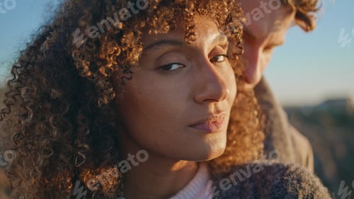 Preview: Enamoured woman looking camera at sunset nature portrait. Diverse lovers faces