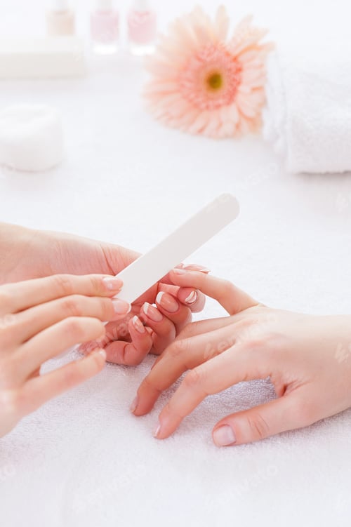 Preview: Polishing female nails. Close-up of beautician polishing nails of female customer