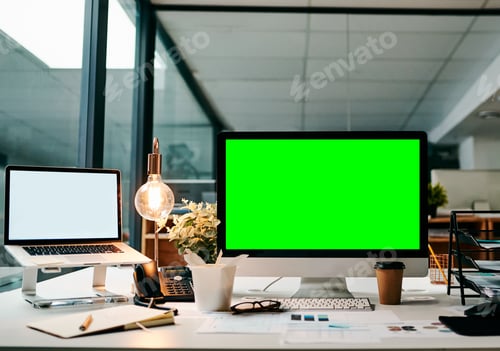 Preview: Shot of a desktop computer with a green screen on a table inside of a office during the day