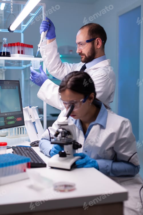 Preview: Scientist examining blood sample looking under microscope