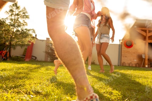 Preview: Friends playing football in the backyard