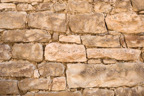 Preview: Masonry walls of natural sand color. Stone texture close-up, construction and mining background.
