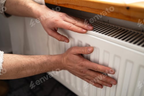 Preview: Man is checking radiator is it heating.
