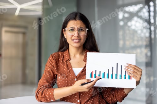 Preview: Businesswoman showing disappointing graph during business meeting presentation