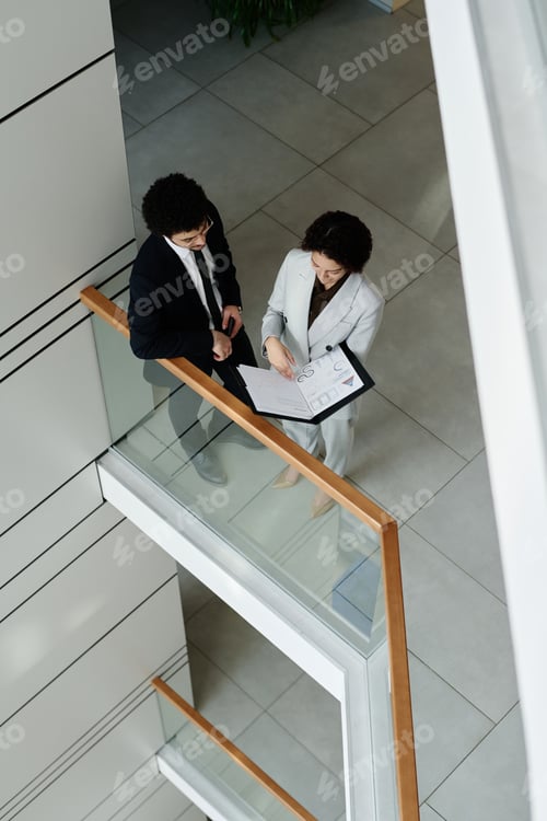 Business colleagues discussing contract in team