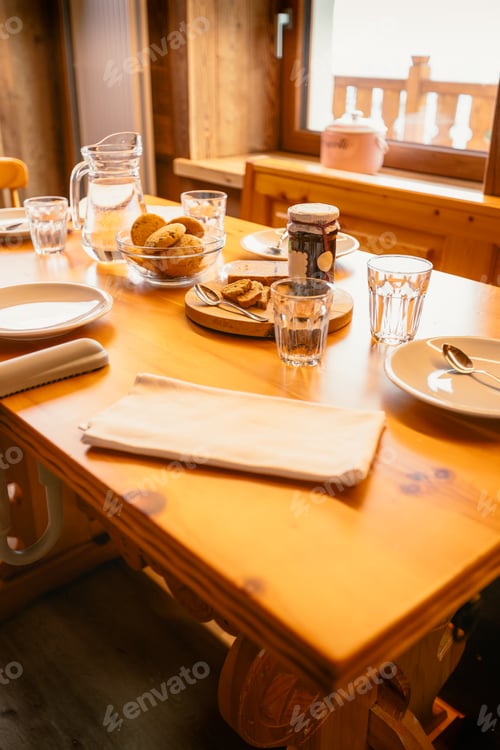 Preview: Wooden mountain house table set for breakfast