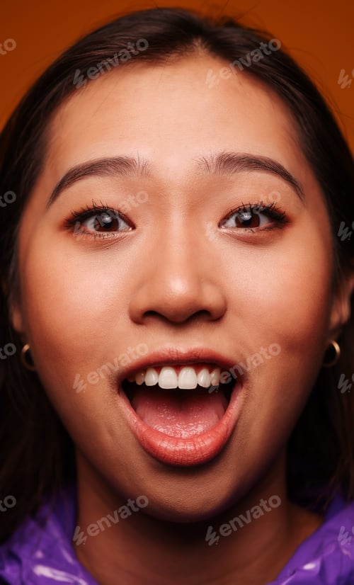 Preview: Young Chinese laughing on yellow background.