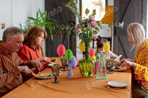 Preview: Family at Easter dinner sitting at the table at home
