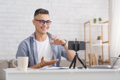 Enthusiastic Young Man Recording Video at Home