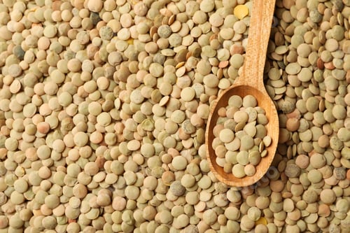 Preview: Uncooked legumes and spoon on whole background, space for text