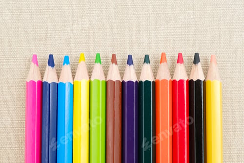 Preview: Colorful sharpened pencils are lined up on the table. Flat lay