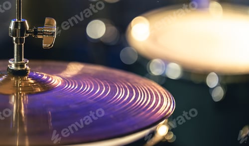 Preview: Drum cymbal close-up on a dark blurred background.