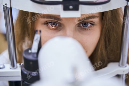Preview: Young woman having eyesight examining in clinic