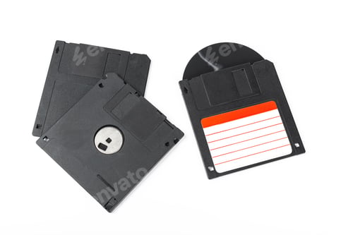 Preview: Old computer storage disks laid out on a white background for vintage technology display
