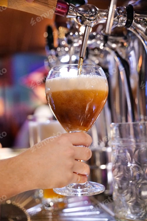 Preview: bartender tapping beer in a pub