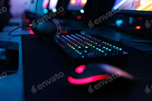 Preview: Computer mouse, keyboard, neon-illuminated headphones for esports, concept of a professional game.