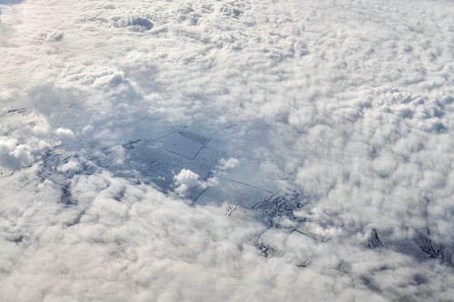 Preview: Over clouds top view from aircraft window, thick white blue clouds looks like soft foam