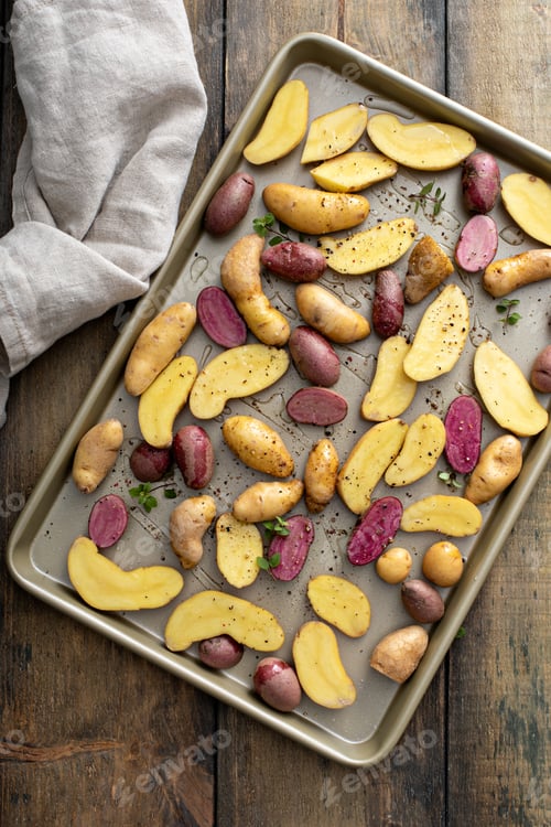 Preview: Yellow and purple fingerling potatoes on a baking sheet