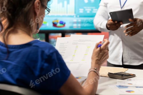 Preview: Senior woman studying potential contract terms in meeting with financial expert