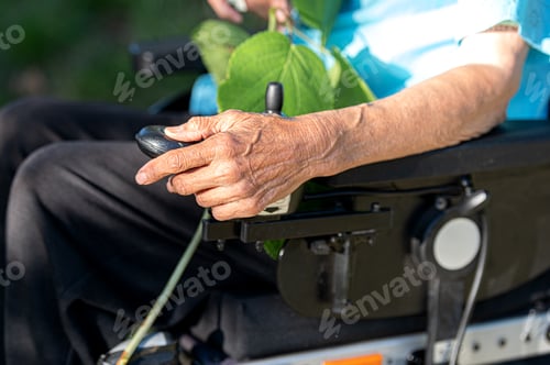 Preview: Elderly hand on a wheelchair.