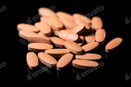 Preview: Close up of Multi Vitamin tablet on a reflective black backgroun