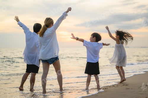 Preview: Happy family enjoying together on beach on holiday vacation