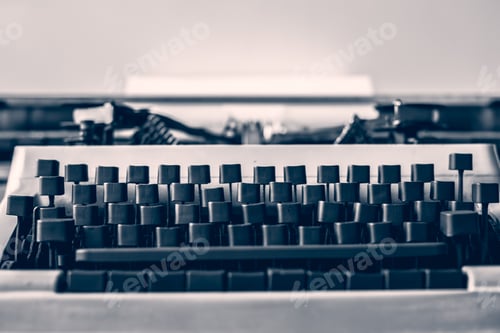 Preview: Vintage typewriter sits on a desk in a cozy room, showcasing craftsmanship and nostalgia