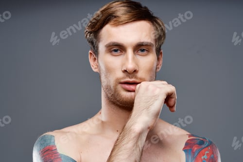 Preview: man with tattoos nude torso bodybuilder phone portrait