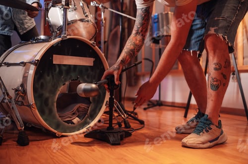 Preview: Close up of a recording microphone being set up in front of a bass drum.