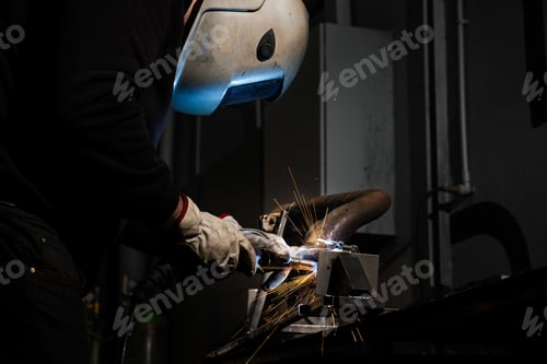 Preview: Worker performs shielded arc welding joining steel with sparks
