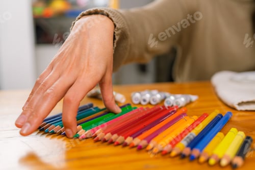 Preview: Graphic designer choosing colored pencils in home studio