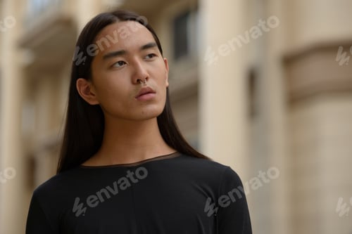 Preview: Portrait of young Asian man with long hair