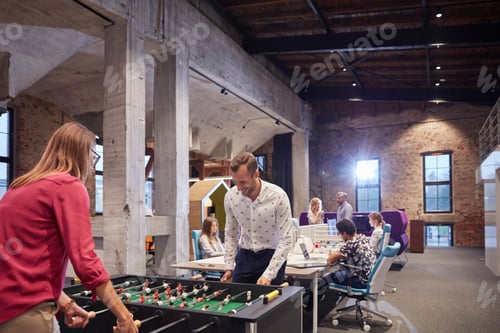 Preview: Business people in office taking a break, playing foosball