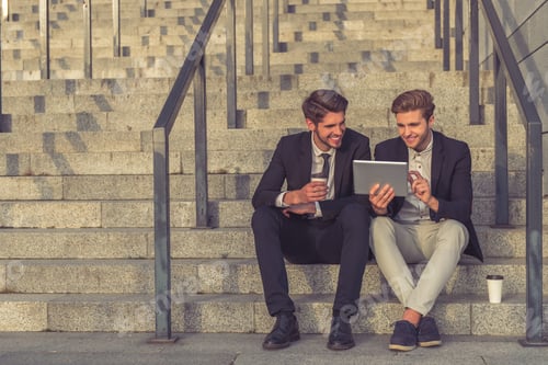 Preview: Handsome young businessmen with gadget